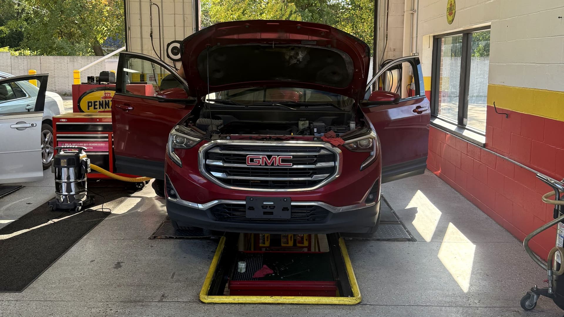 SUV in a drive-thru bay at Redford Auto 10 Min Oil Change on 7 Mile